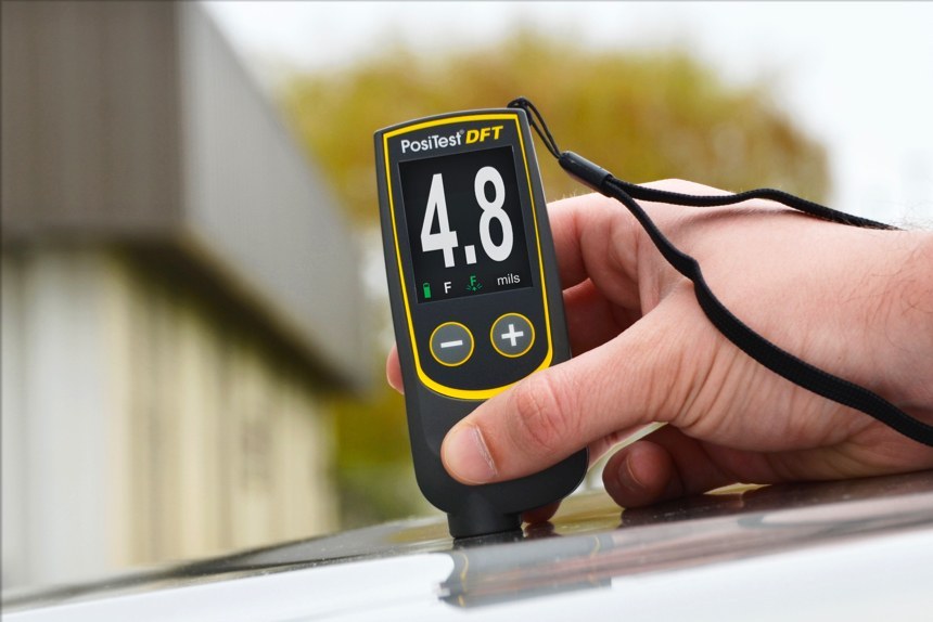 PosiTest DFT measuring paint thickness on an automobile hood