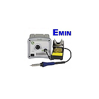 Technician working on an electronic soldering station repair bench