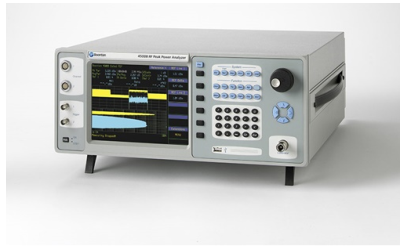 Technician handling a portable power quality analyzer during inspection